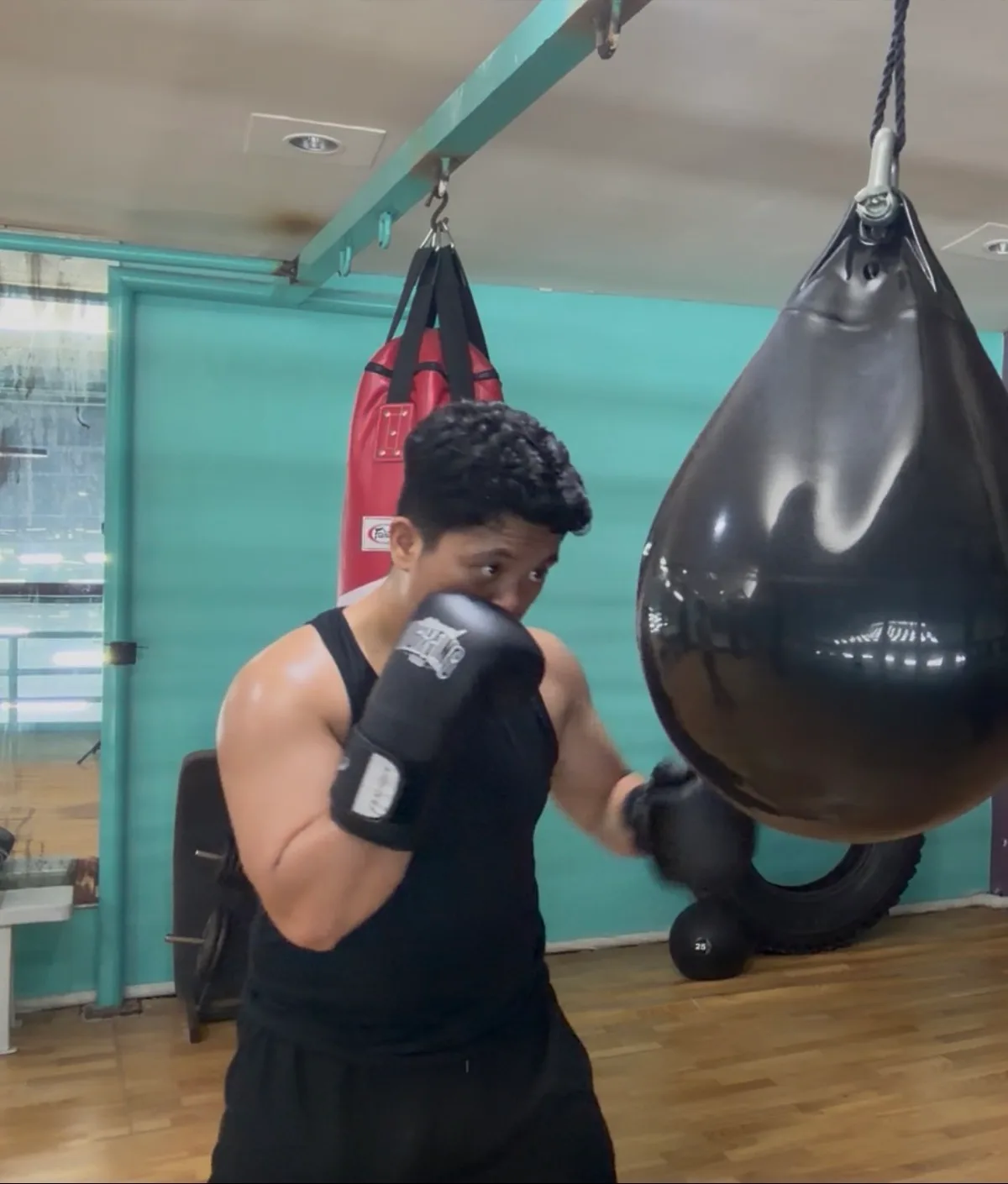 Boxing training with a heavy bag at the gym