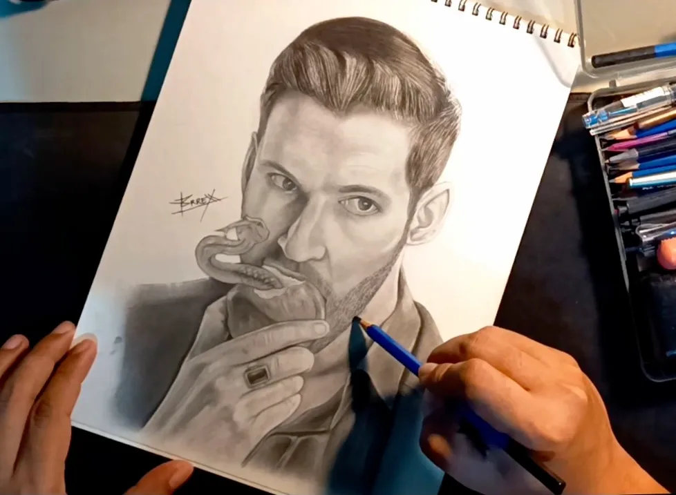 Hands working on a detailed pencil portrait in a sketchbook